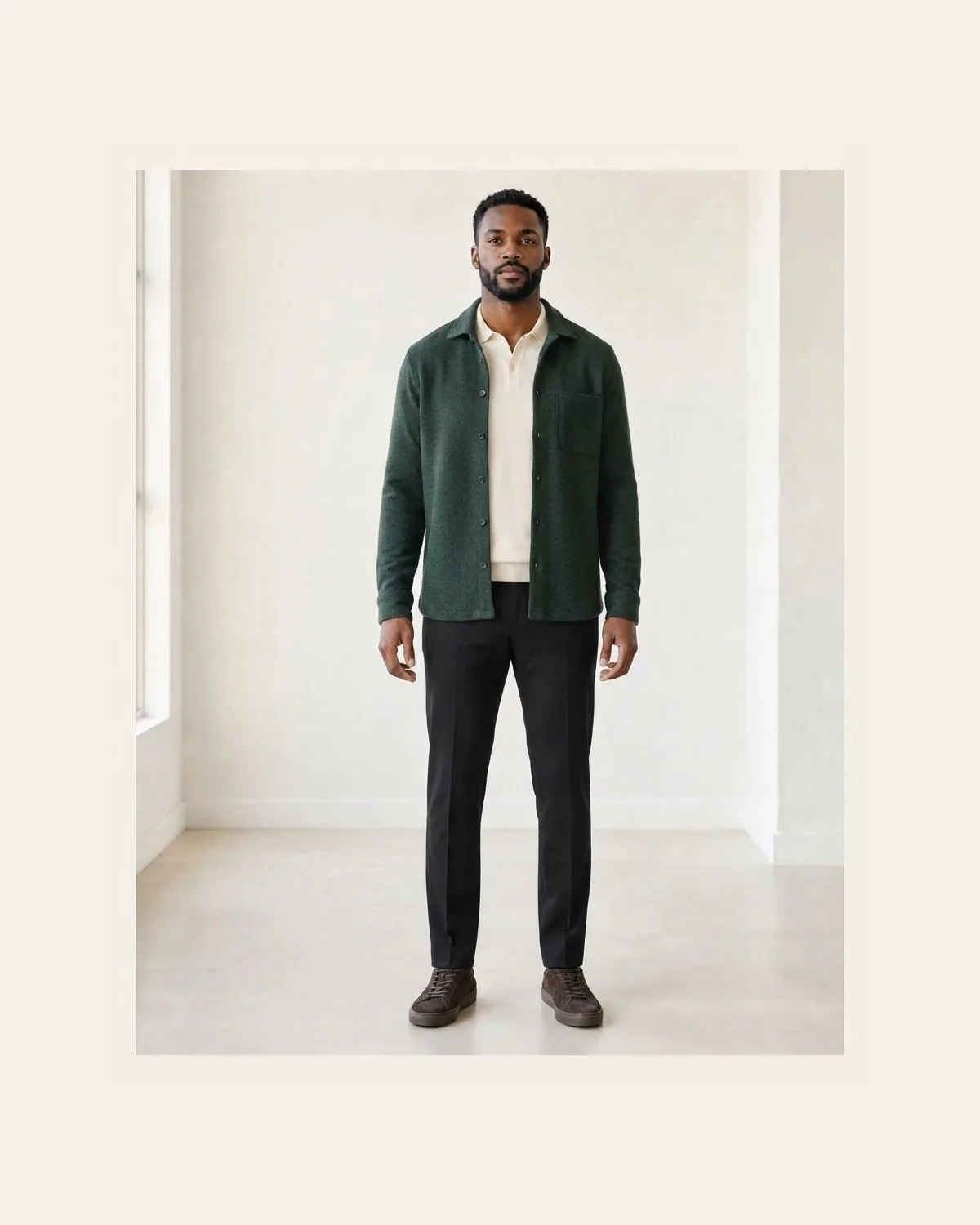 Forest green overshirt, cream polo, and black trousers