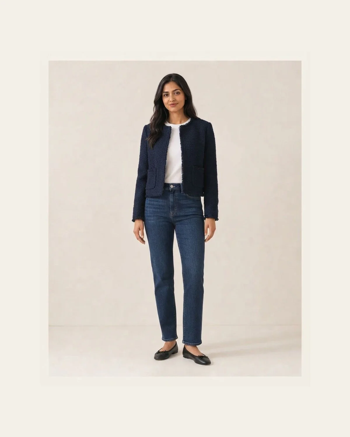 Navy textured jacket, white top, straight jeans, and black flats
