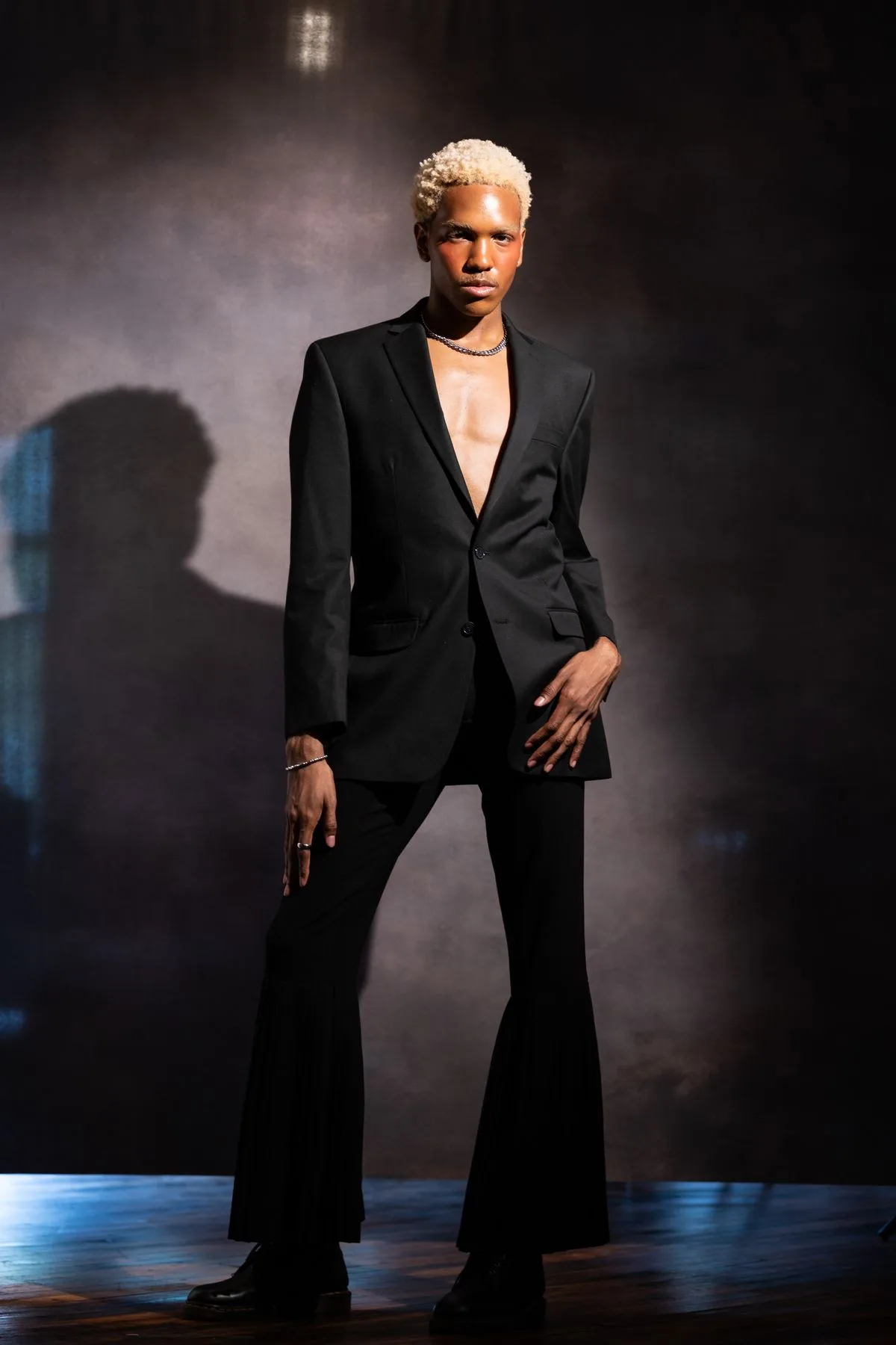 Deep black suit with open neckline and minimal styling