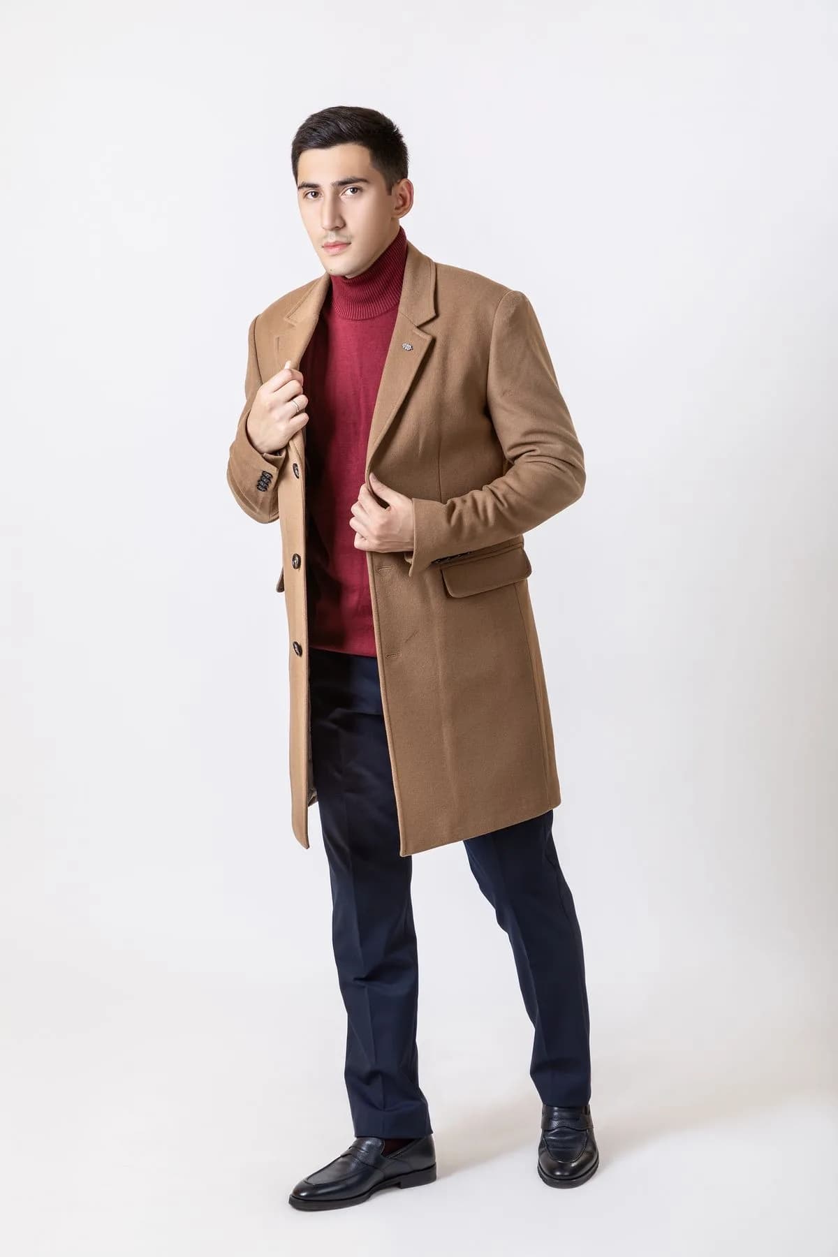 Camel overcoat with merlot turtleneck and dark trousers