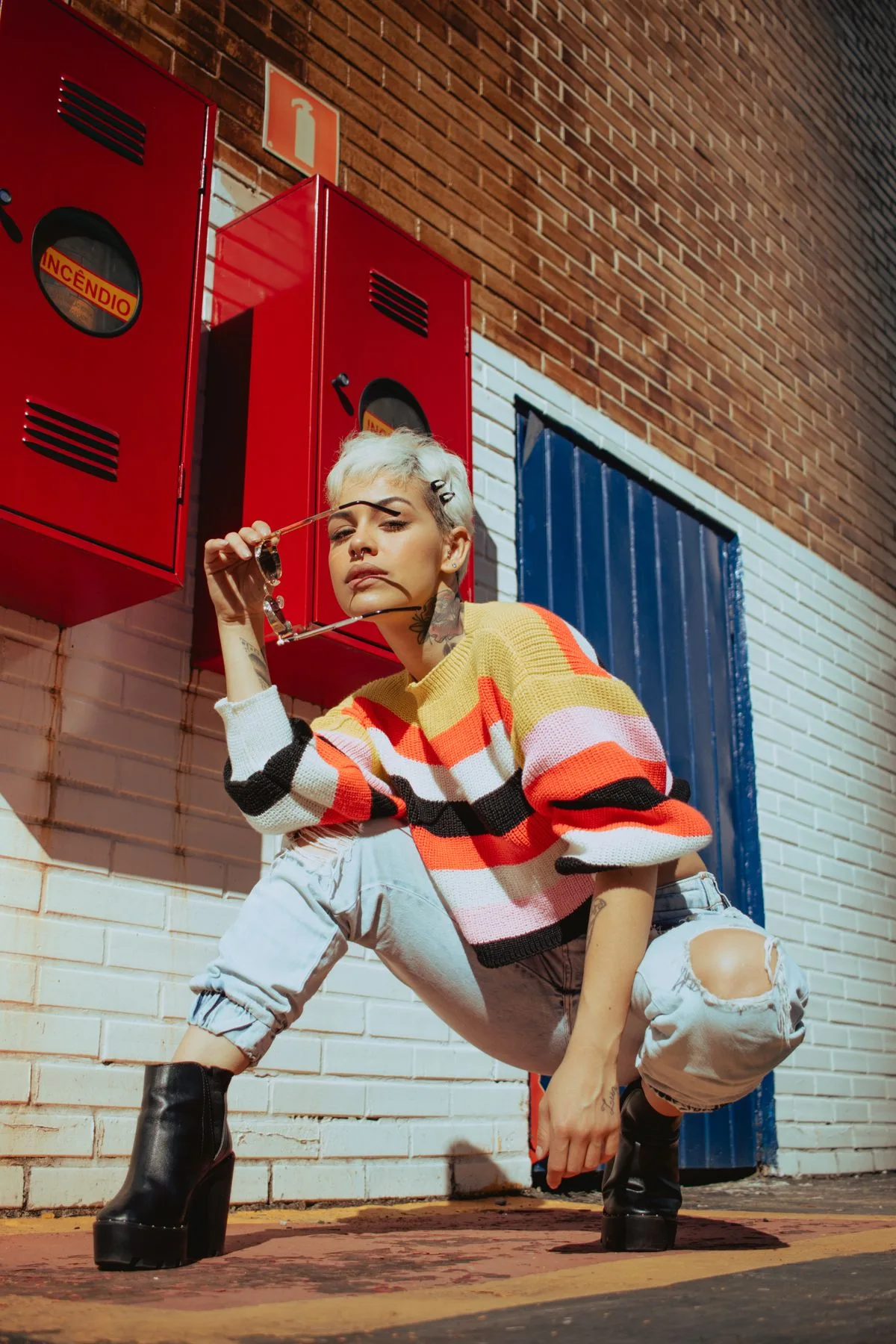Colorful striped knit, white utility trousers, and black platform boots