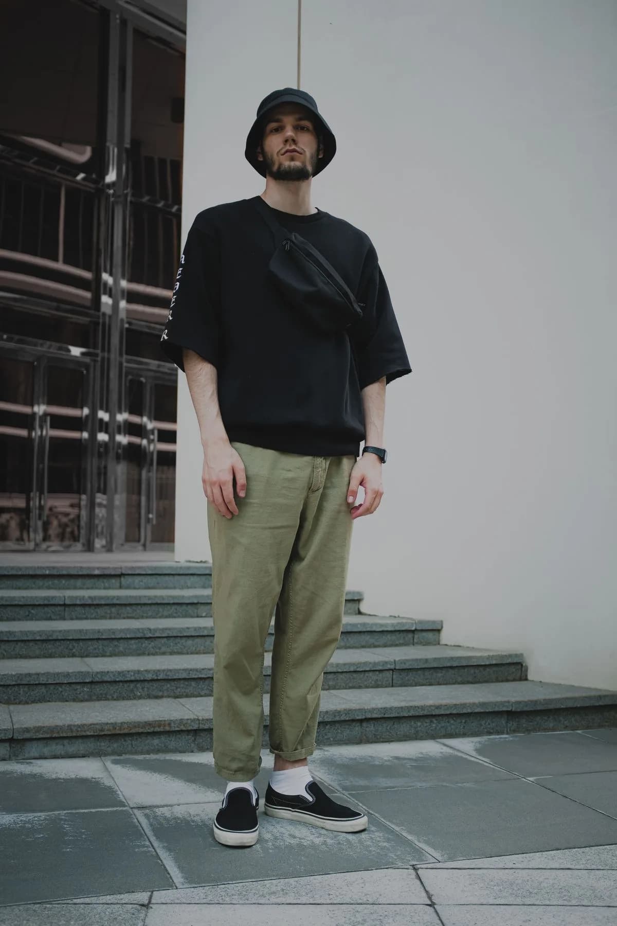 Oversized black tee with olive trousers and black sneakers