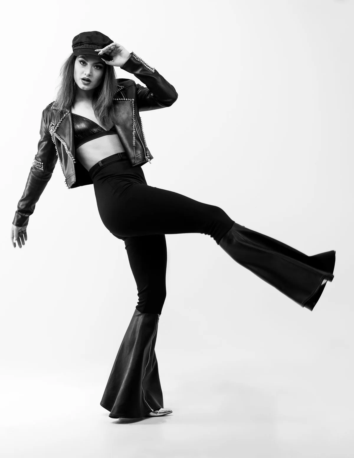 Black leather jacket with flared trousers and brimmed hat