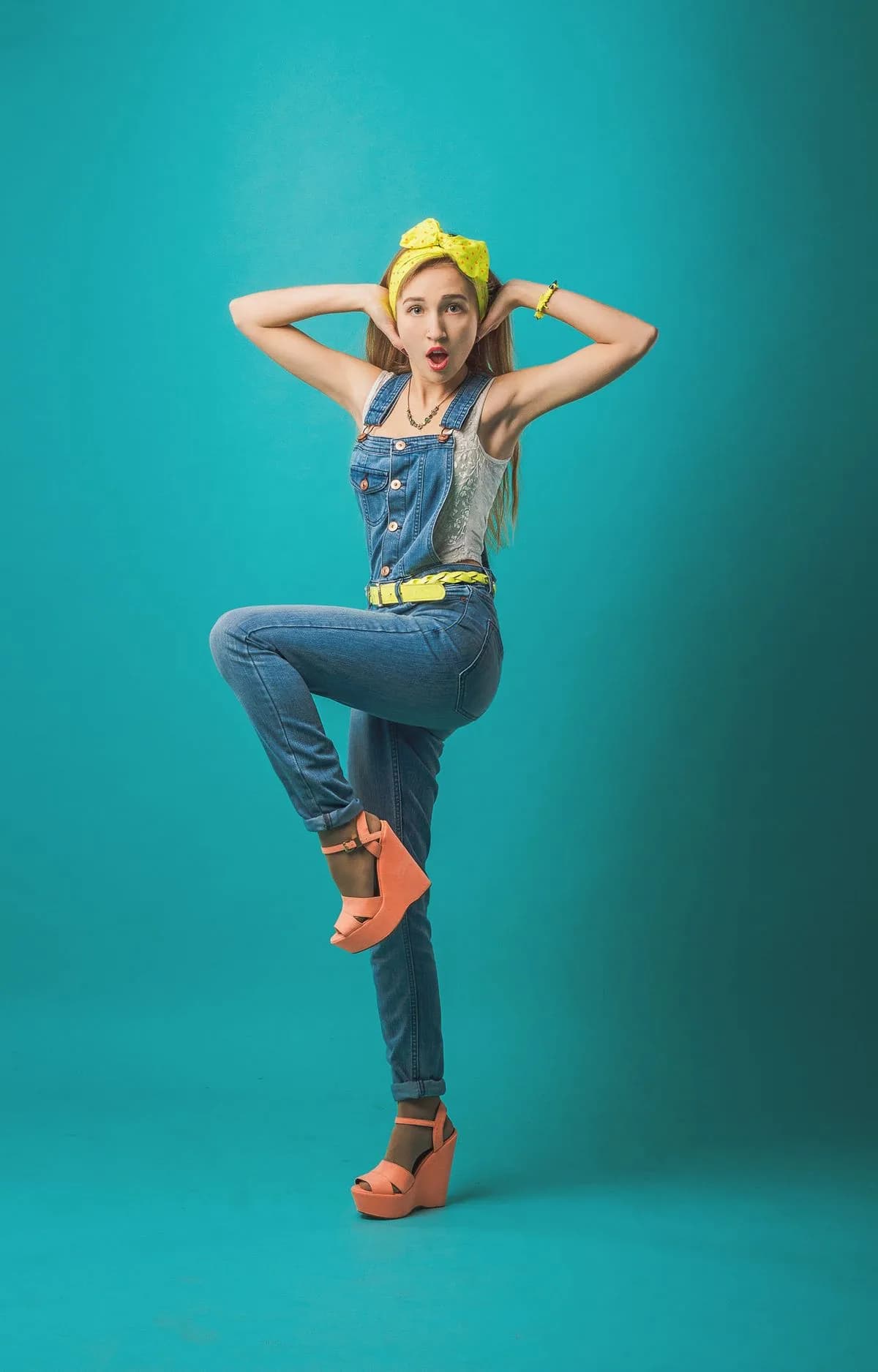 Denim overalls with orange sandals and yellow accessories